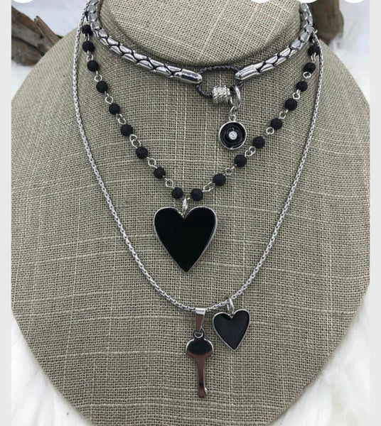 Three necklaces in black accent